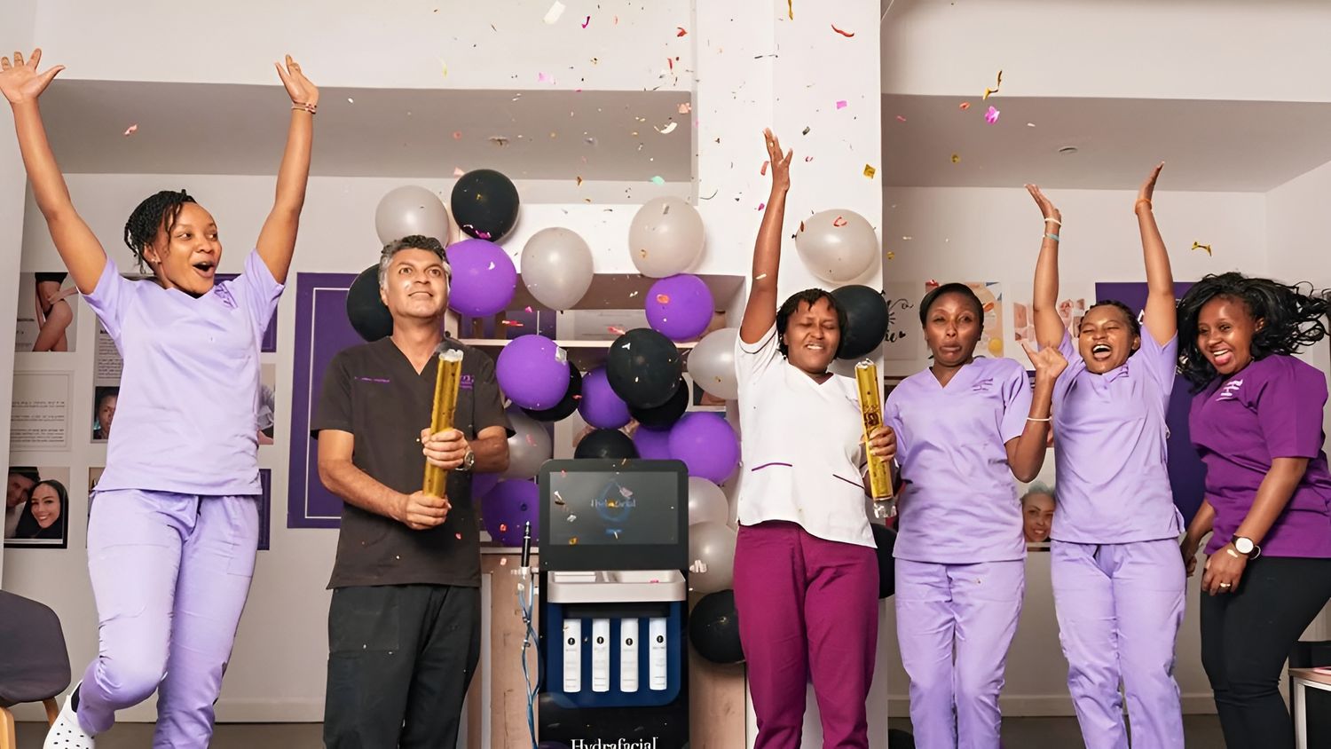 Celebration among staff with confetti and balloons.