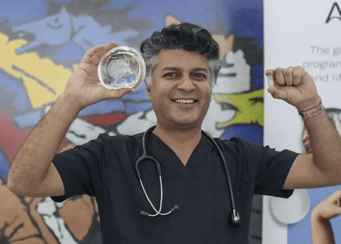 Doctor holding medical implants with a stethoscope.
