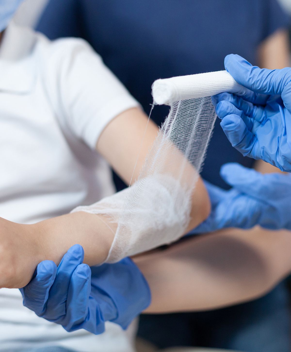 Applying a bandage to a child's arm.