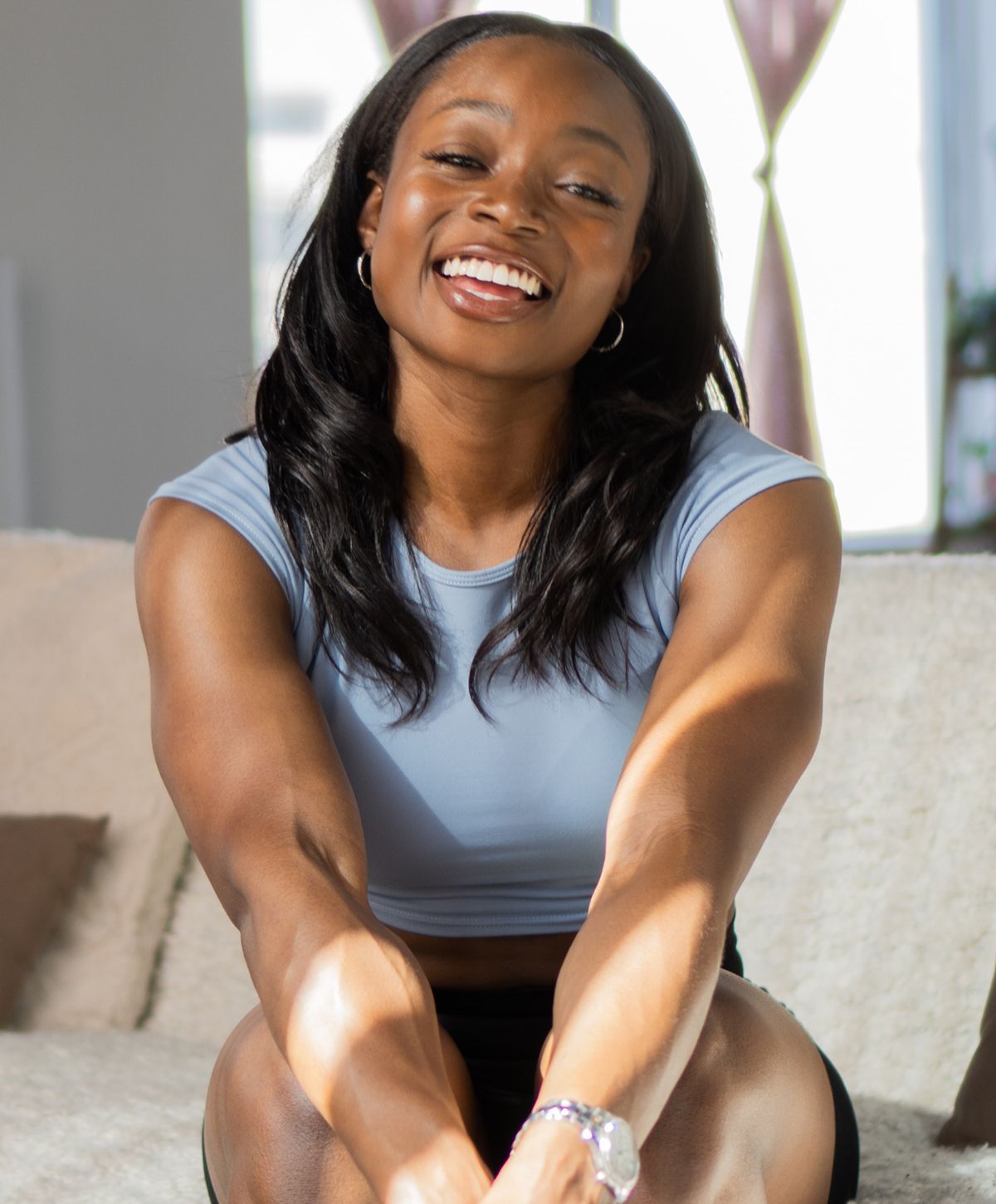 Close-up of a woman relaxing with neutral background.