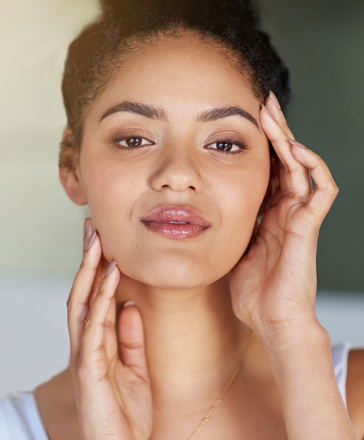 Close-up of a woman relaxing with neutral background.