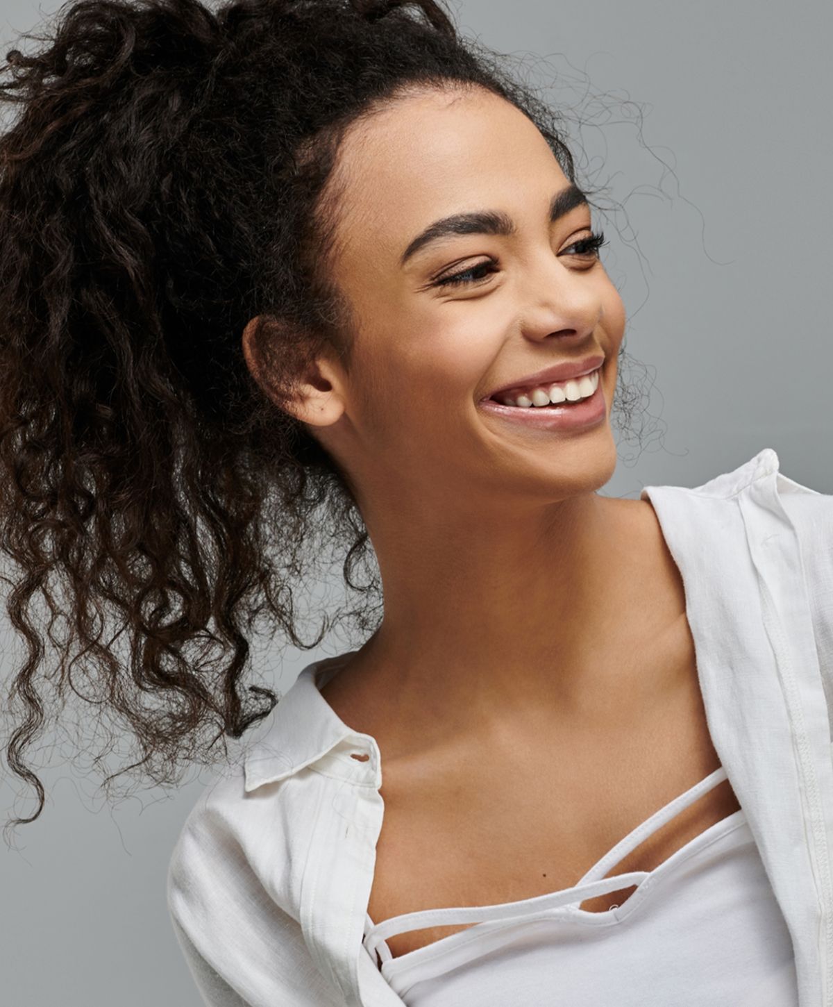 Close-up of a woman relaxing with neutral background.