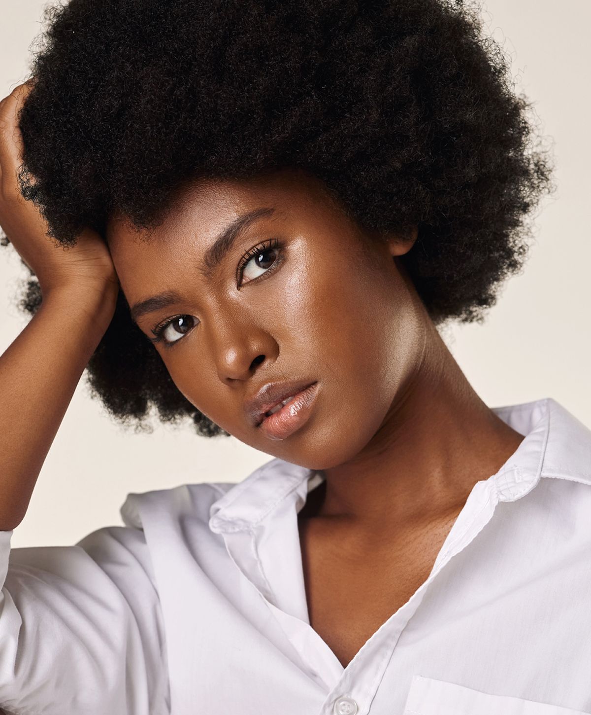 Close-up of a woman relaxing with neutral background.