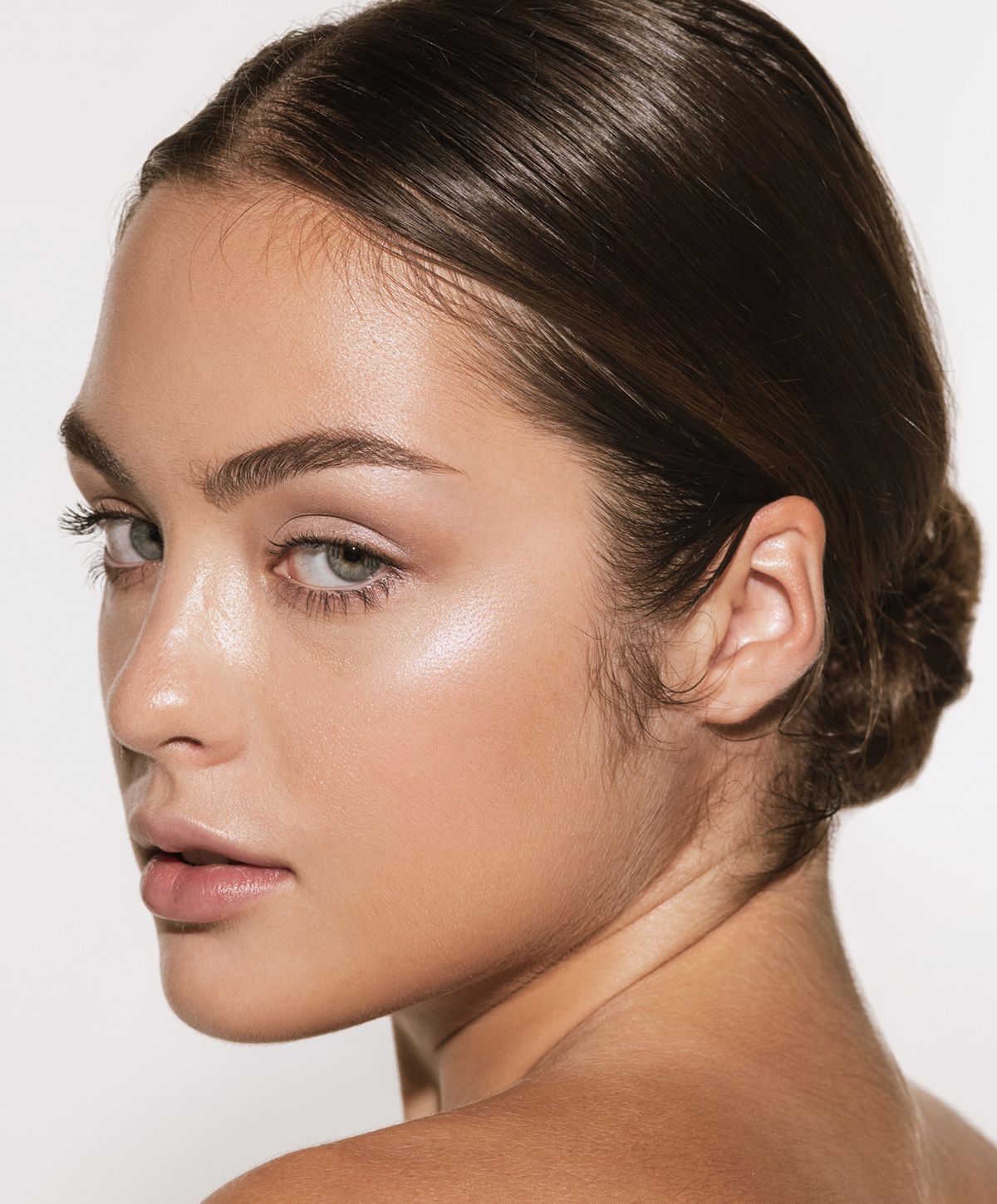 Close-up of a woman relaxing with neutral background.