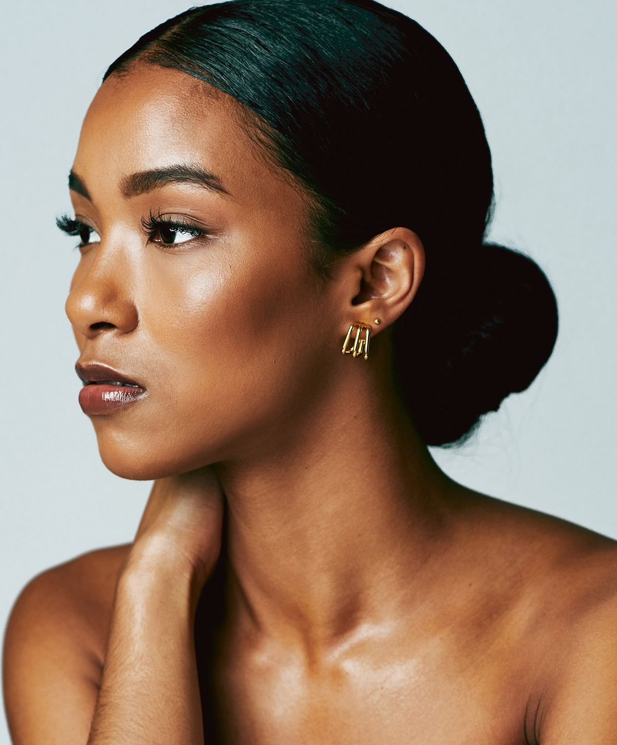 Close-up of a woman relaxing with neutral background.