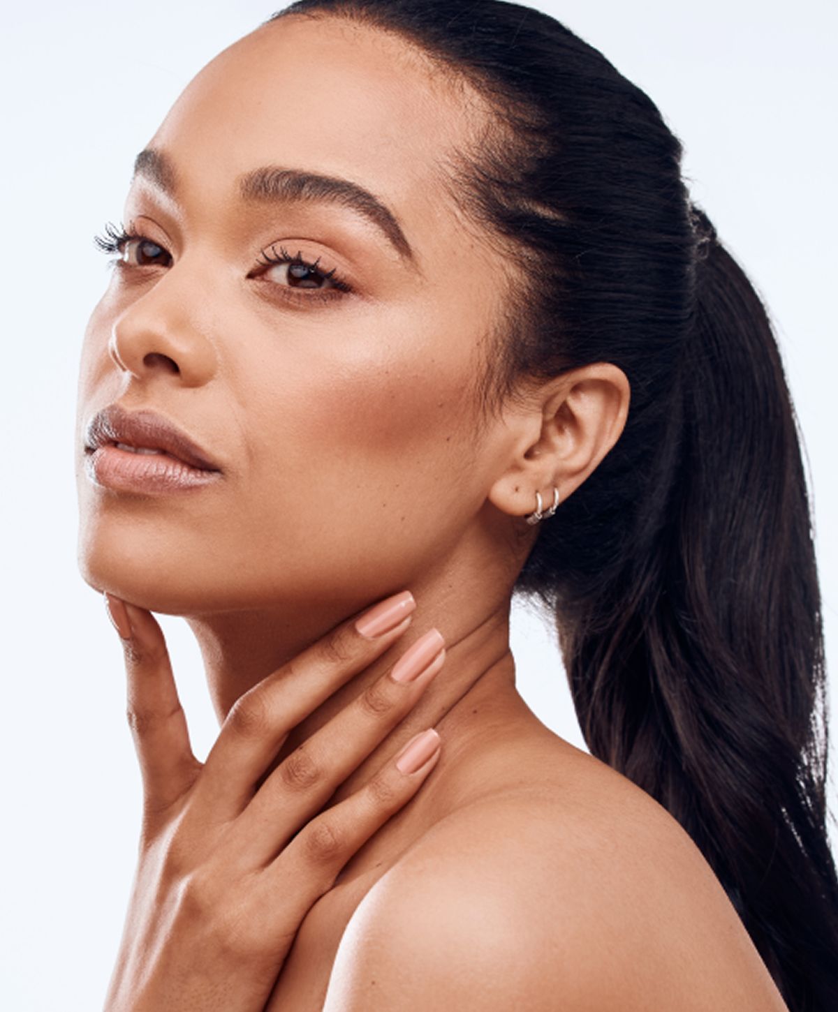 Close-up of a woman relaxing with neutral background.