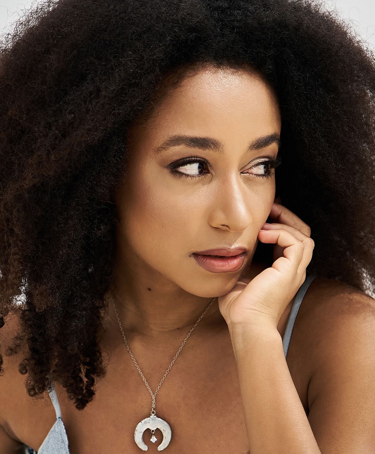 Close-up of a woman relaxing with neutral background.