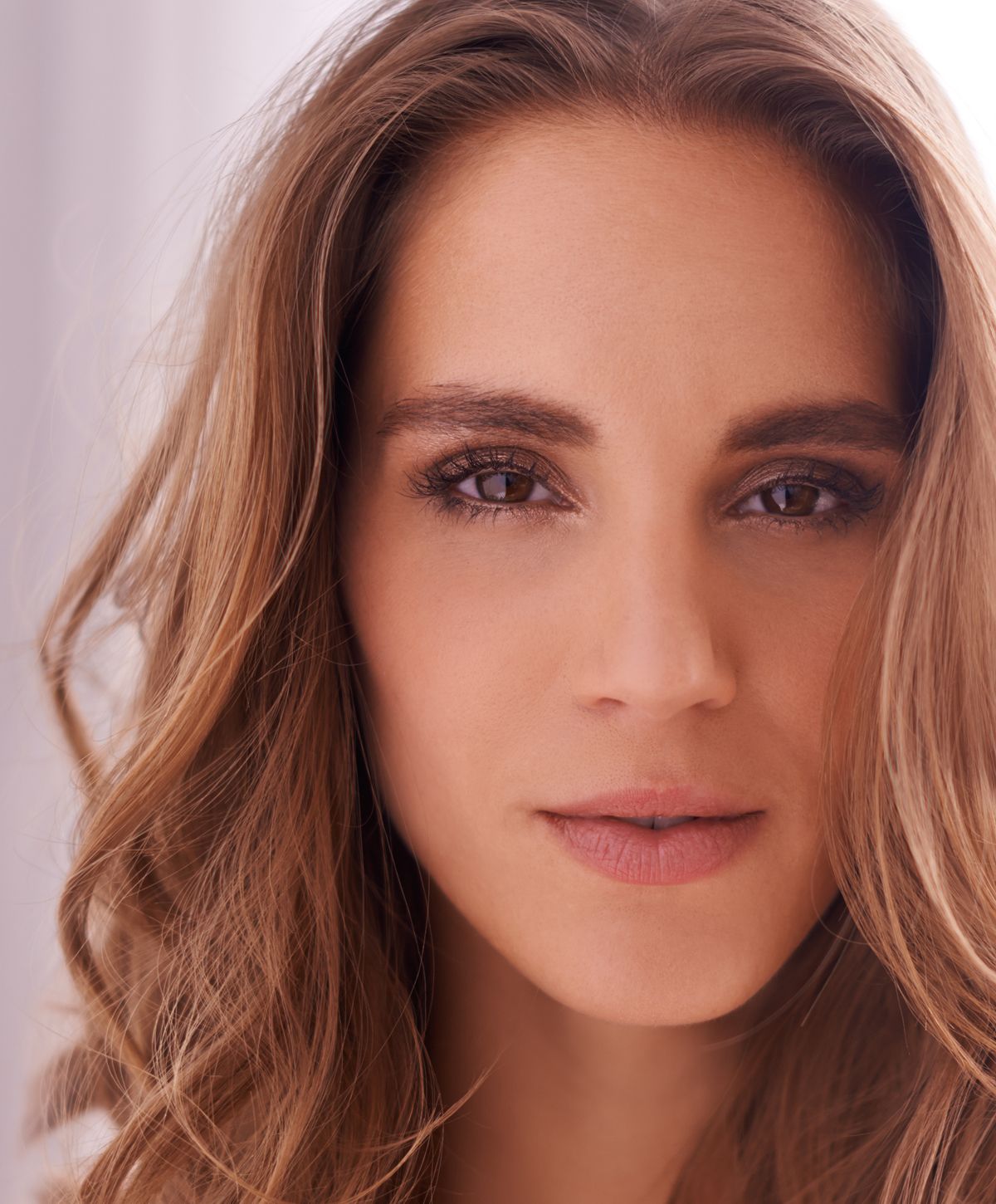 Close-up of a woman with wavy hair.