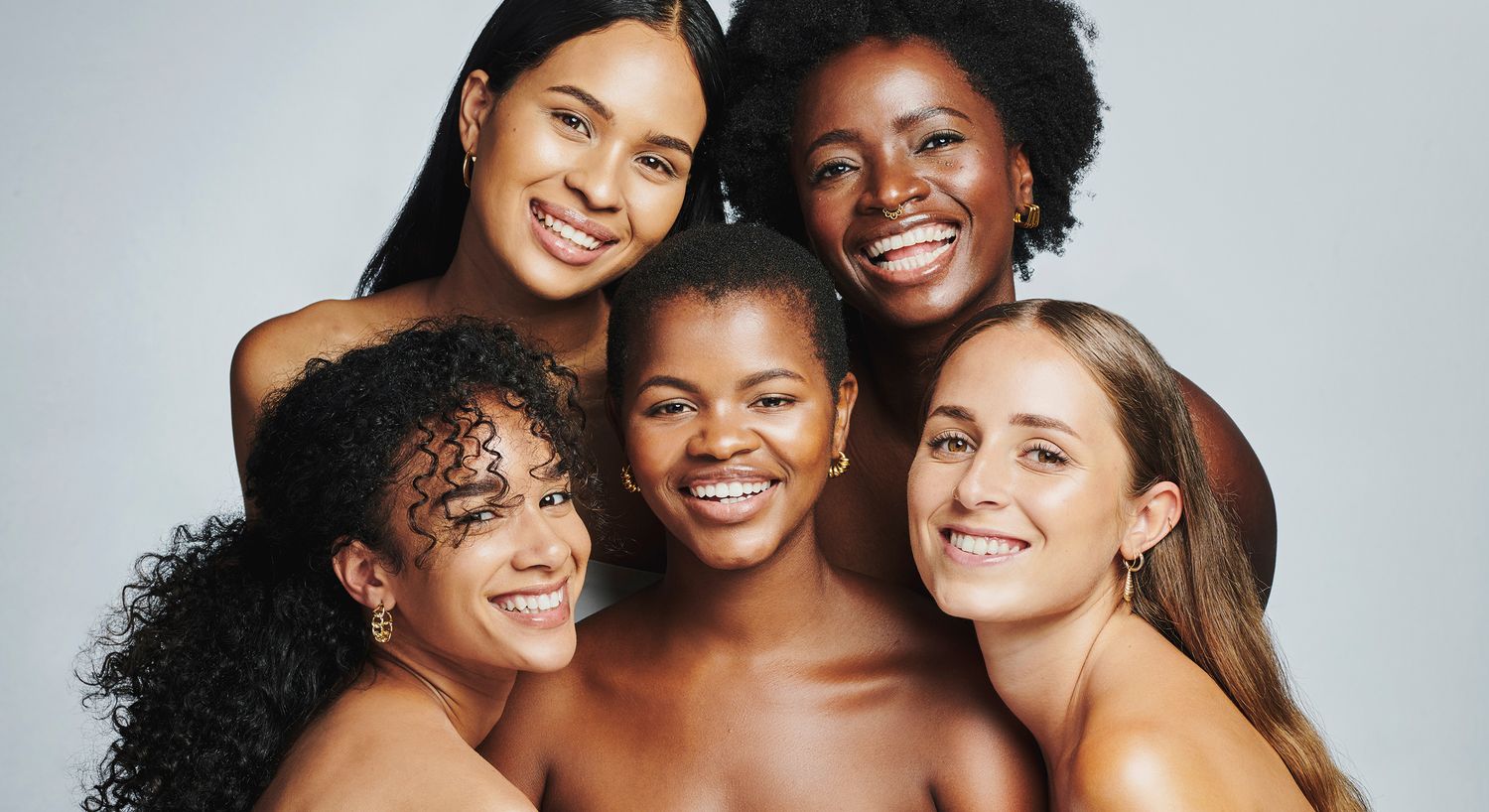Diverse group of smiling women in studio.