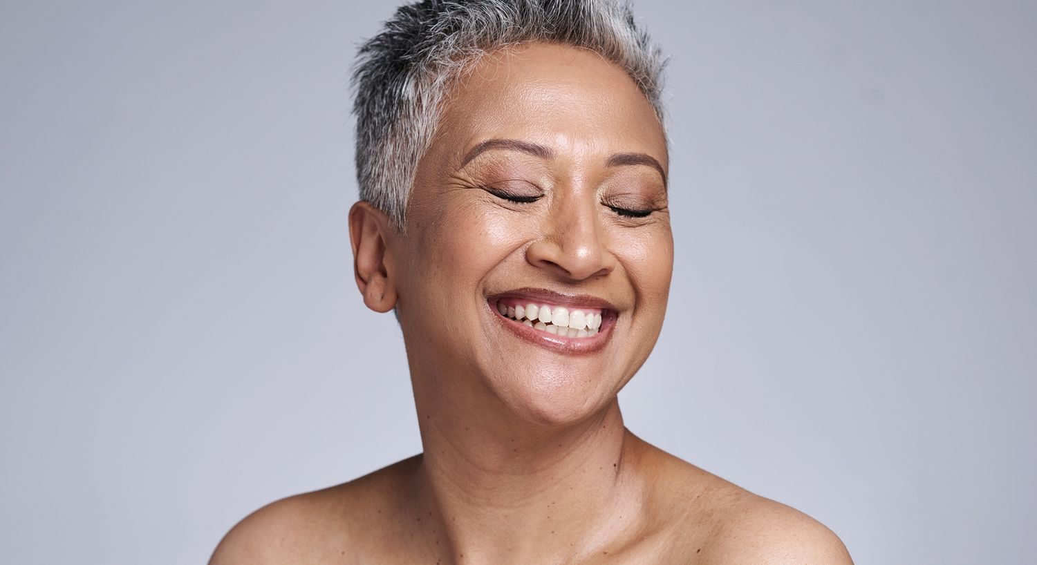 Smiling woman with short gray hair.