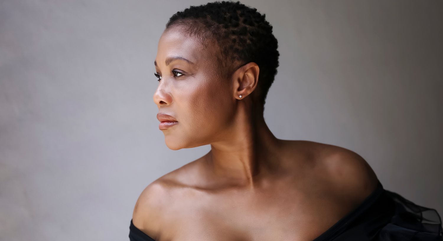 Profile portrait of a woman in soft lighting.