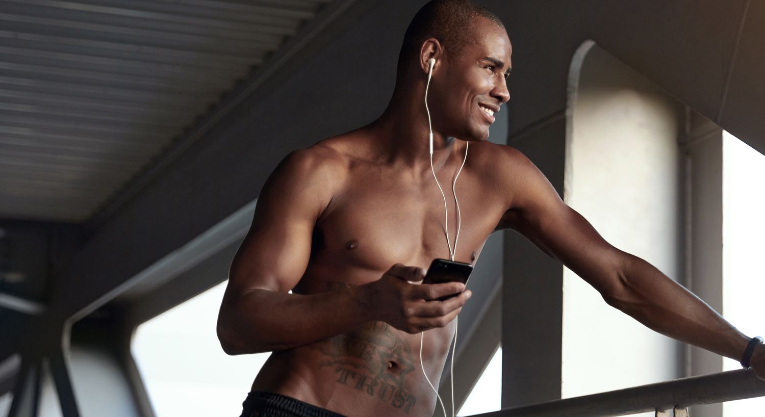 Man listening to music and checking phone.