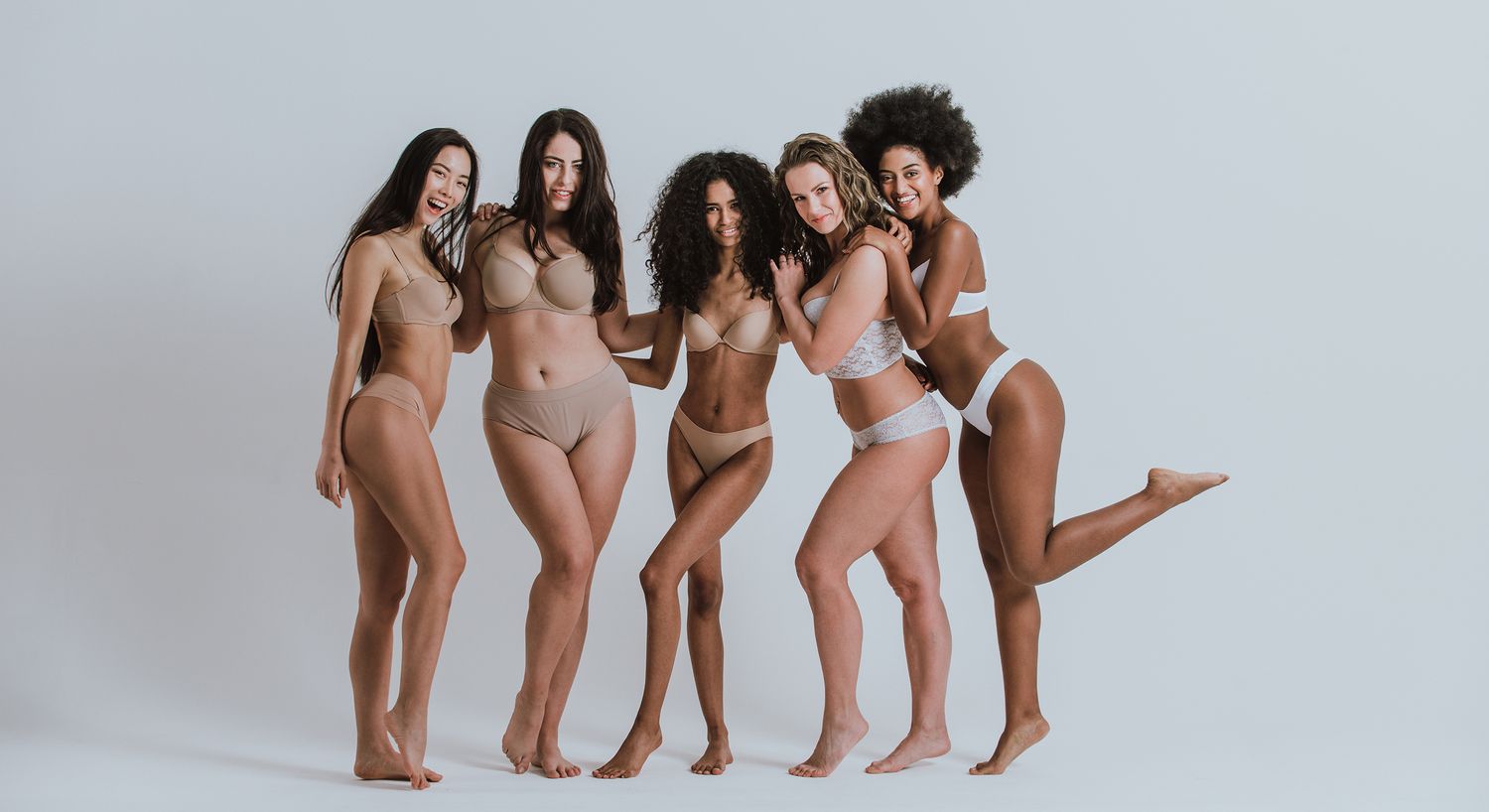 Diverse women posing in stylish lingerie.